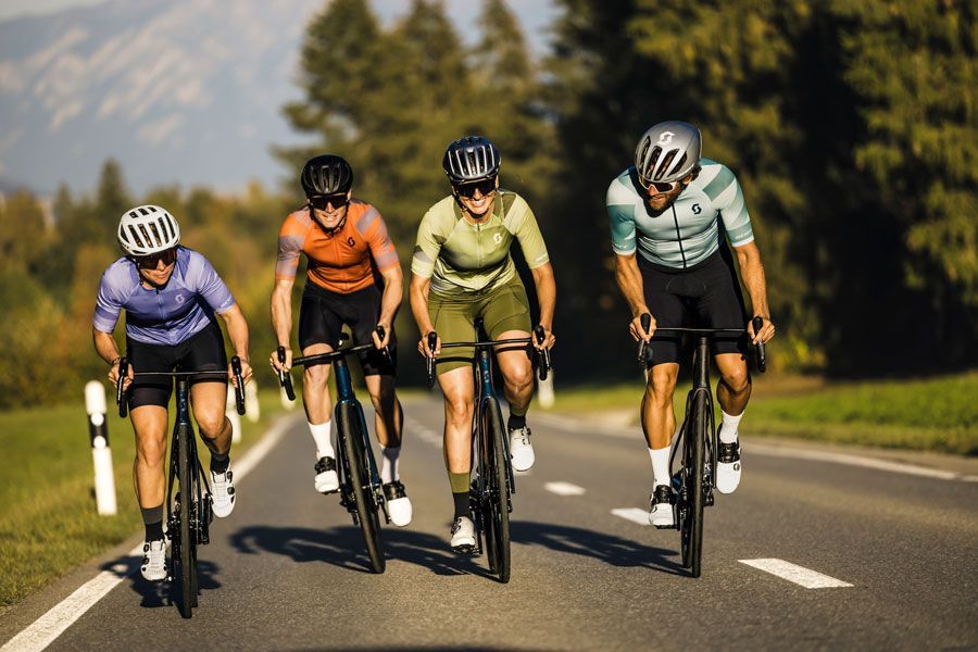 Eine Gruppe von Leuten fährt mit Fahrrädern eine Straße entlang.