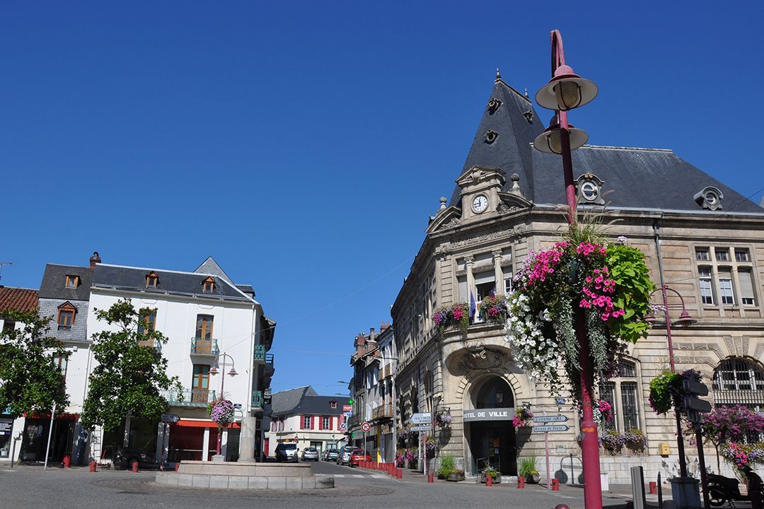 Pièce partiellement rénovée avec solives apparentes au plafond, cloisons sèches et matériaux de construction au sol.