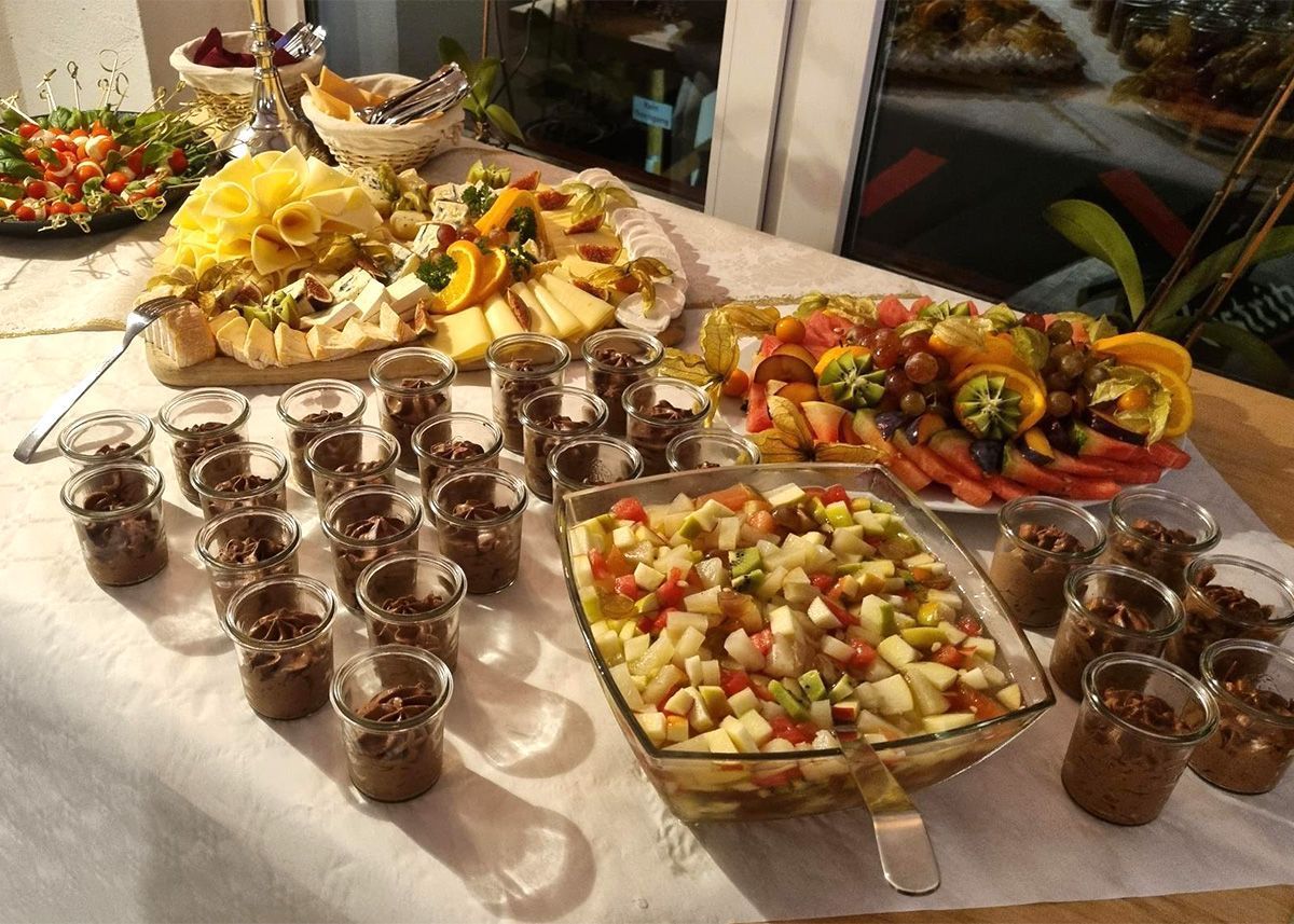 Buffet mit Obstplatten, Schokoladenmoussebechern und gemischtem Obstsalat in einem Bankettsaal