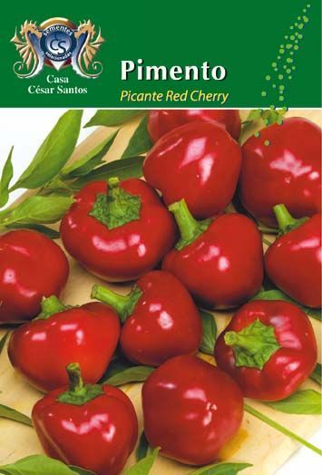 Red cherry peppers piled on a market-style label with green background and “Pimento” text