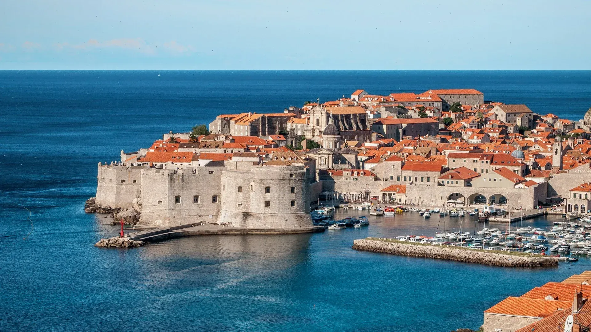 The historic walled city of Dubrovnik, Croatia, with terracotta rooftops along the Adriatic Sea coast.