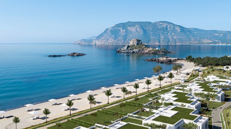 Discover an Ikos Resort, by the sea, mountain in the background