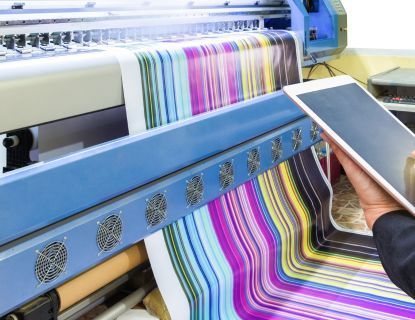 Large format printer printing colorful stripes, controlled by tablet.