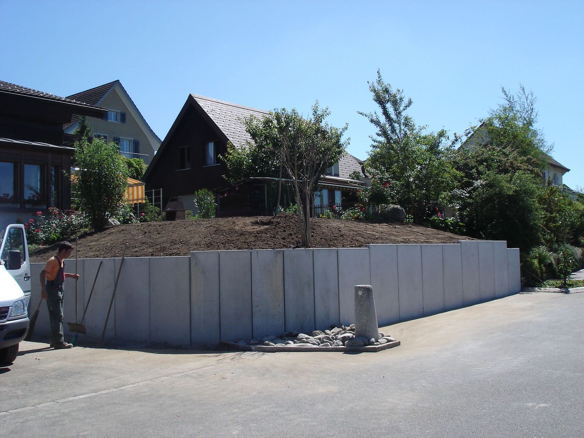 Vor einem Haus wird eine Betonmauer errichtet