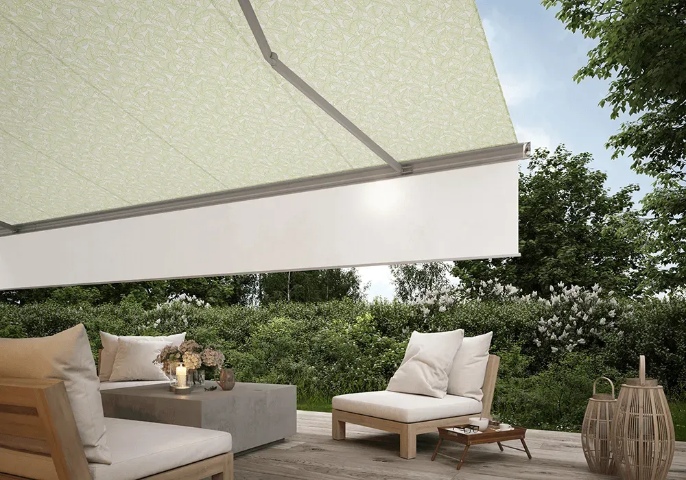 Eine Terrasse mit Sofa, Stühlen und Tisch unter einer Markise.