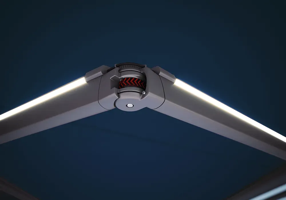 Eine Nahaufnahme eines beleuchteten Regenschirms vor einem dunkelblauen Himmel.