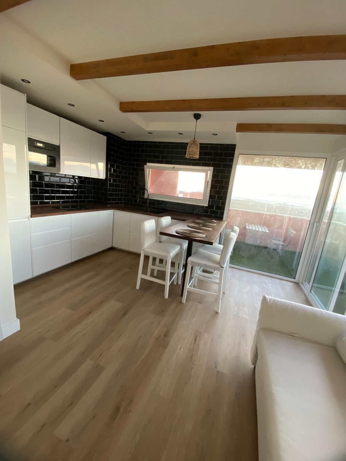 Una cocina con una mesa y sillas y un sofá.