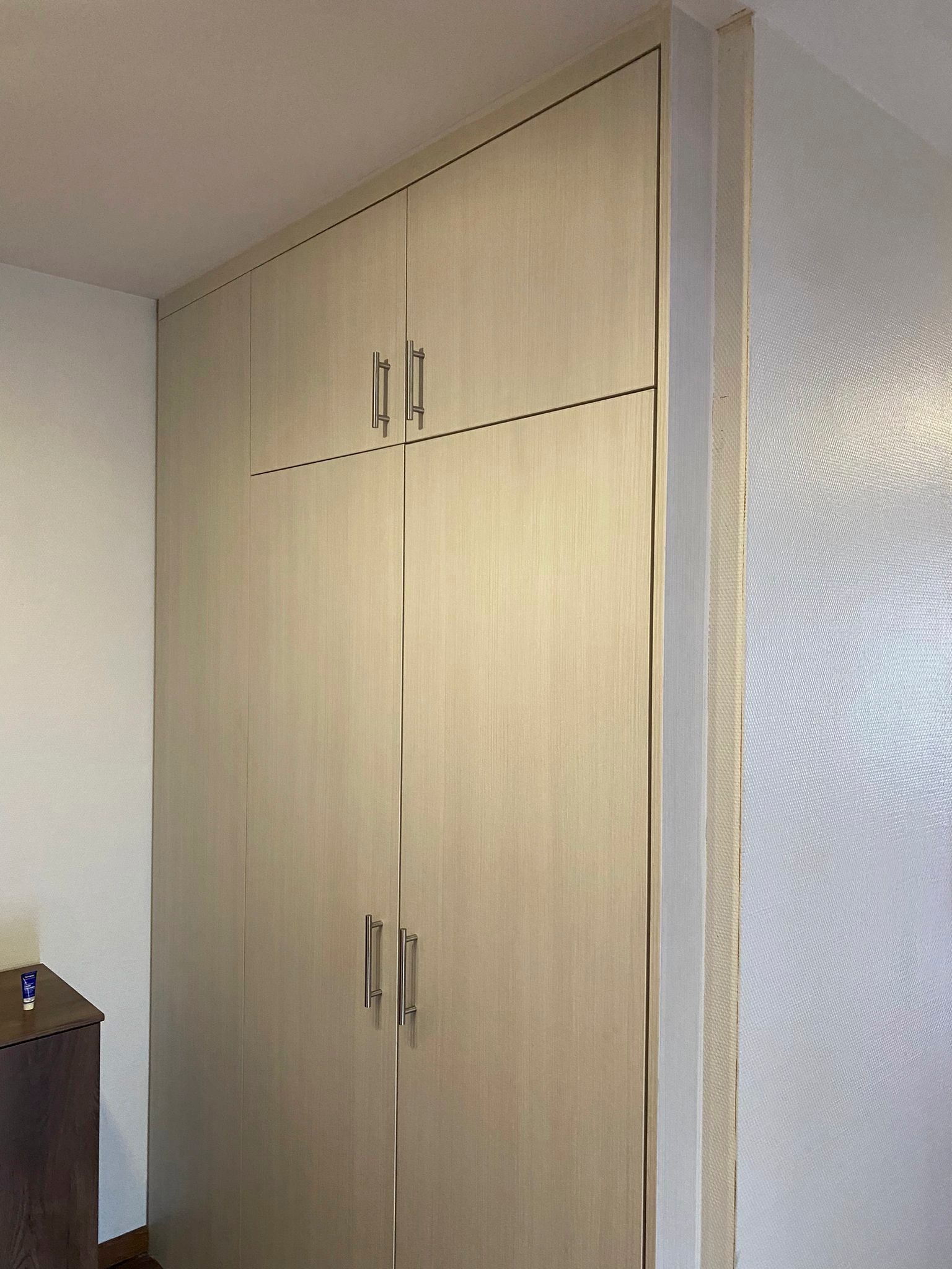 Ein Schlafzimmer mit einem großen Holzkleiderschrank mit zwei Türen.