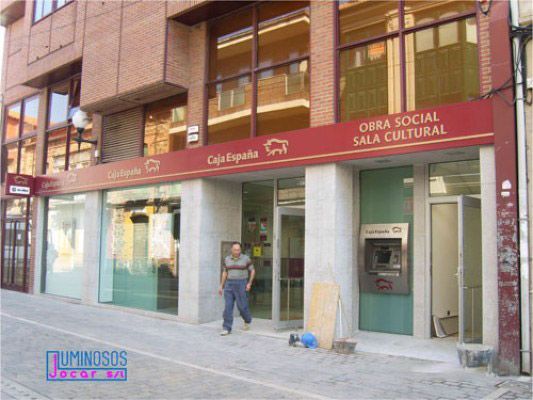 Un hombre parado frente a un edificio que dice obra social sala cultural