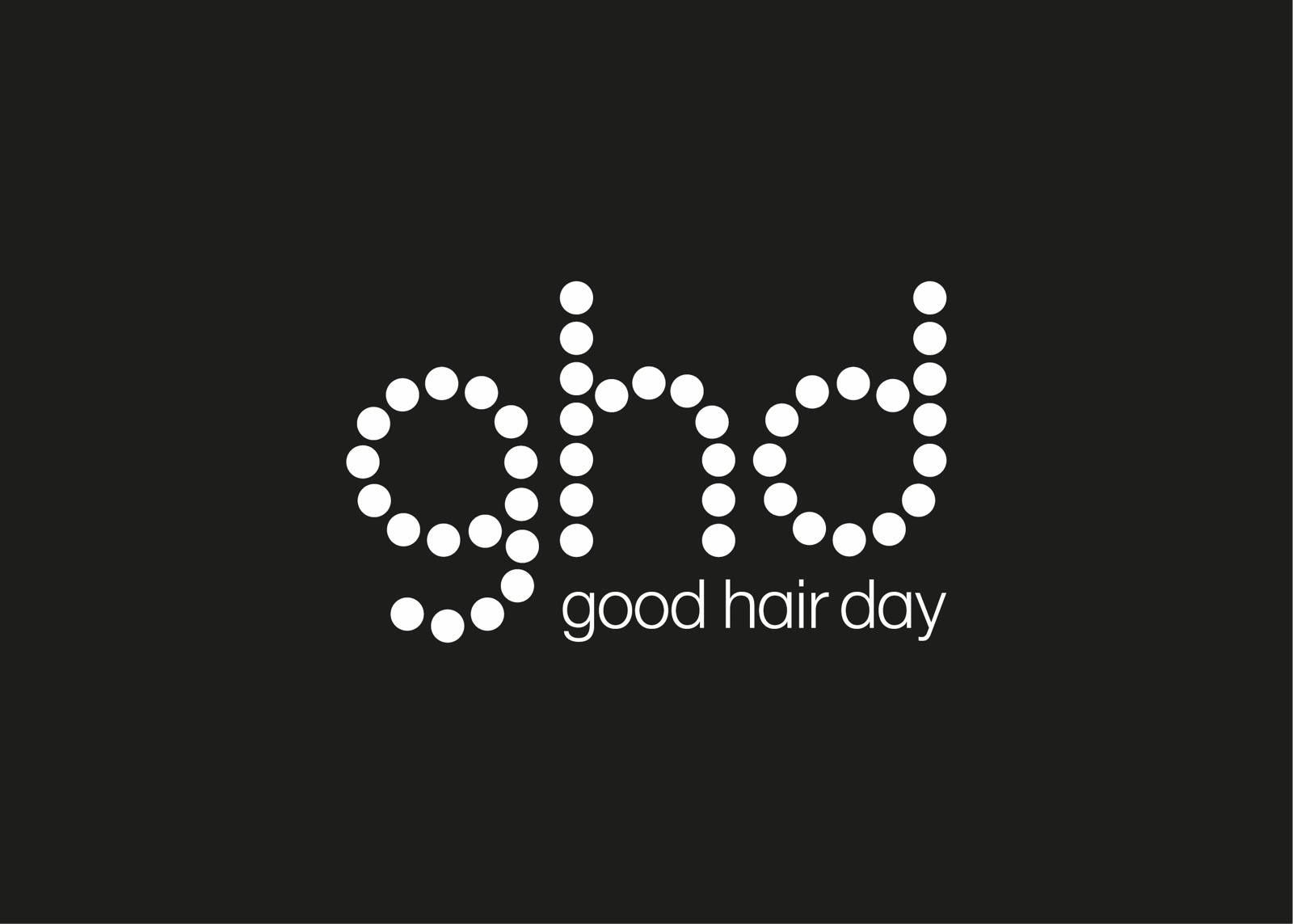 Weiß gepunktetes „ghd“-Logo mit „good hair day“ darunter auf schwarzem Hintergrund