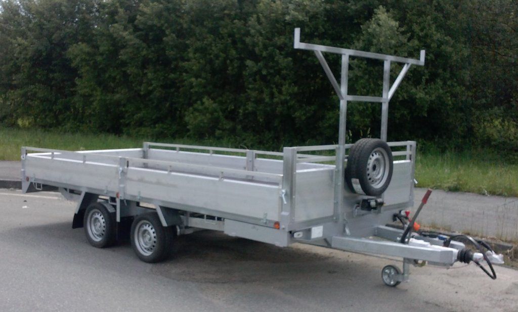 Un remolque con una escalera adjunta está estacionado al costado de la carretera.