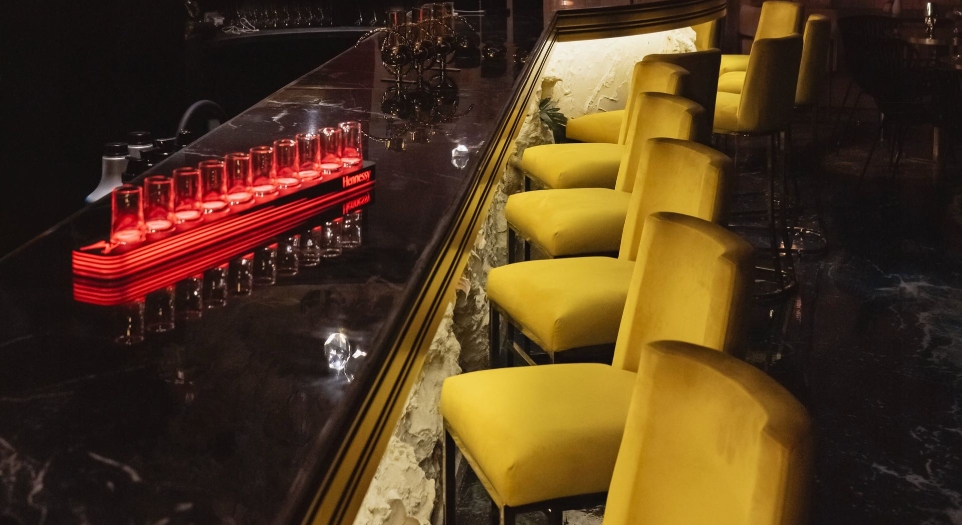 Bar avec chaises jaunes et verres à shooter