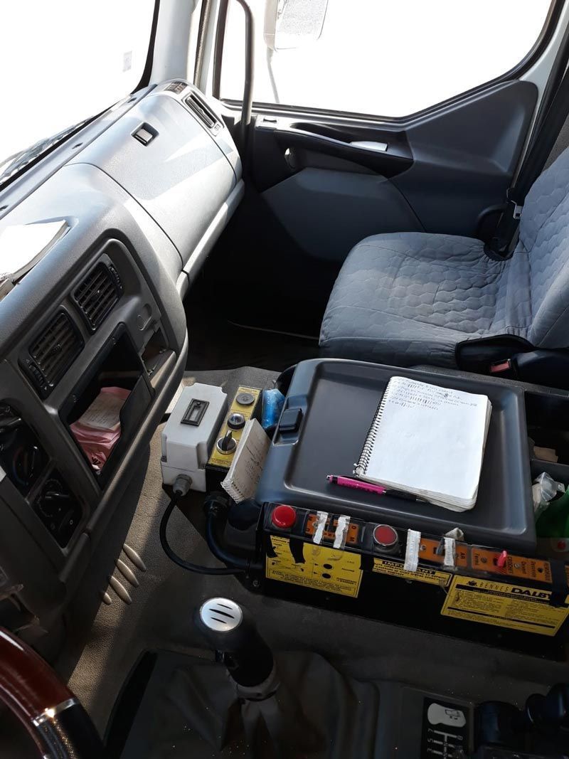 El interior de un camión con un cuaderno en el apoyabrazos.
