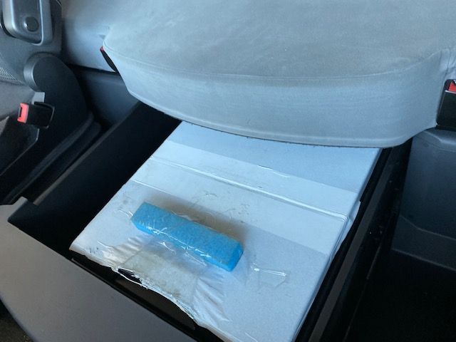 Una caja blanca con un artículo azul dentro.