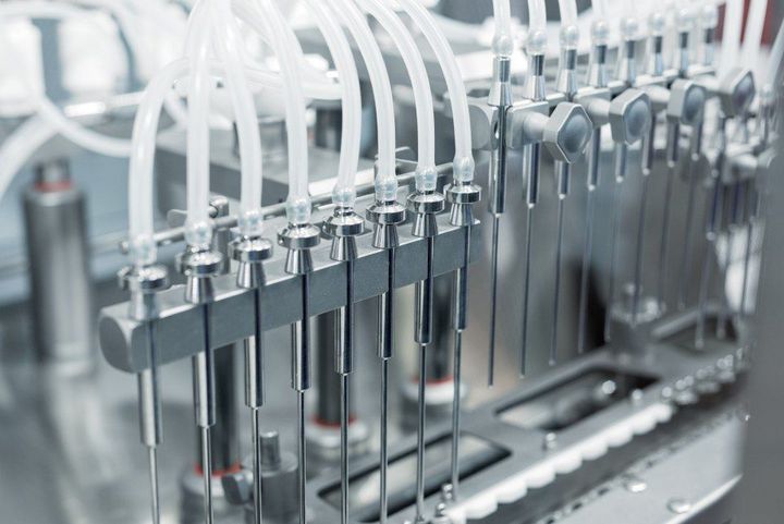 A person works on a machine in a factory.