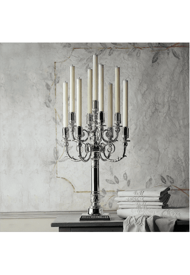 Elegante Kerzenständer mit edlem Standfuss vor einer hellen Wand.