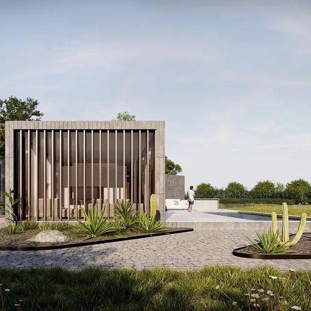 Un hombre está parado frente a una casa con una valla alrededor.