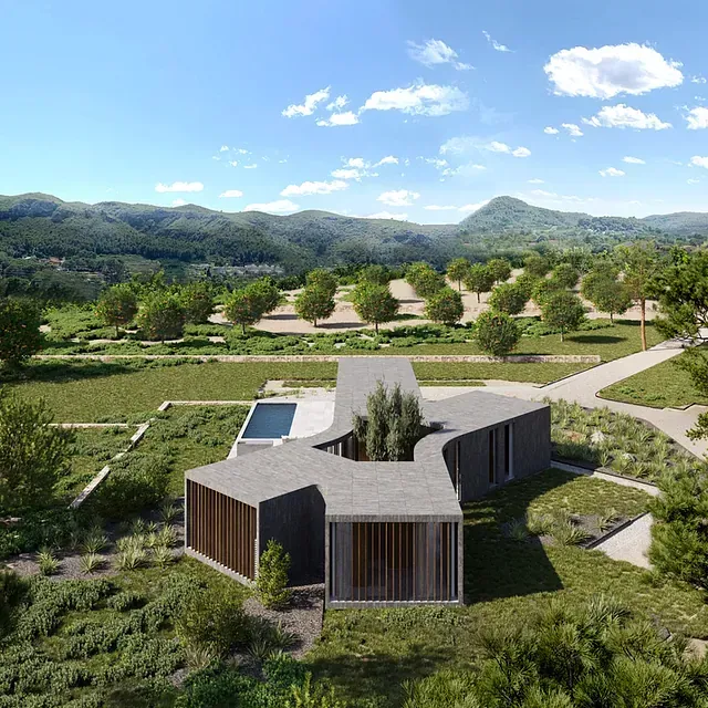 Una vista aérea de una casa en medio de un campo con montañas al fondo.