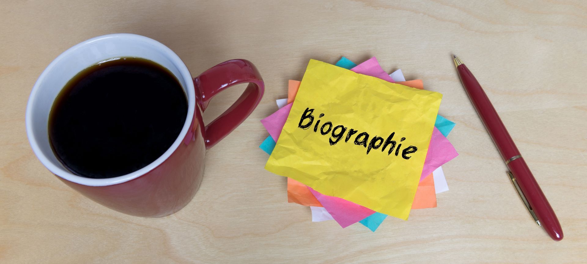 Tasse de café avec un postit intitulé Biographie