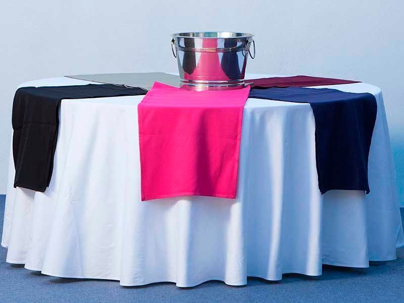 Una mesa con un cubo de champán encima.