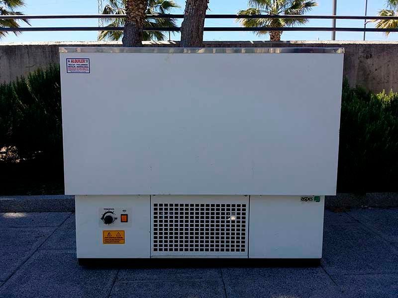 Un gran congelador blanco está en una acera.