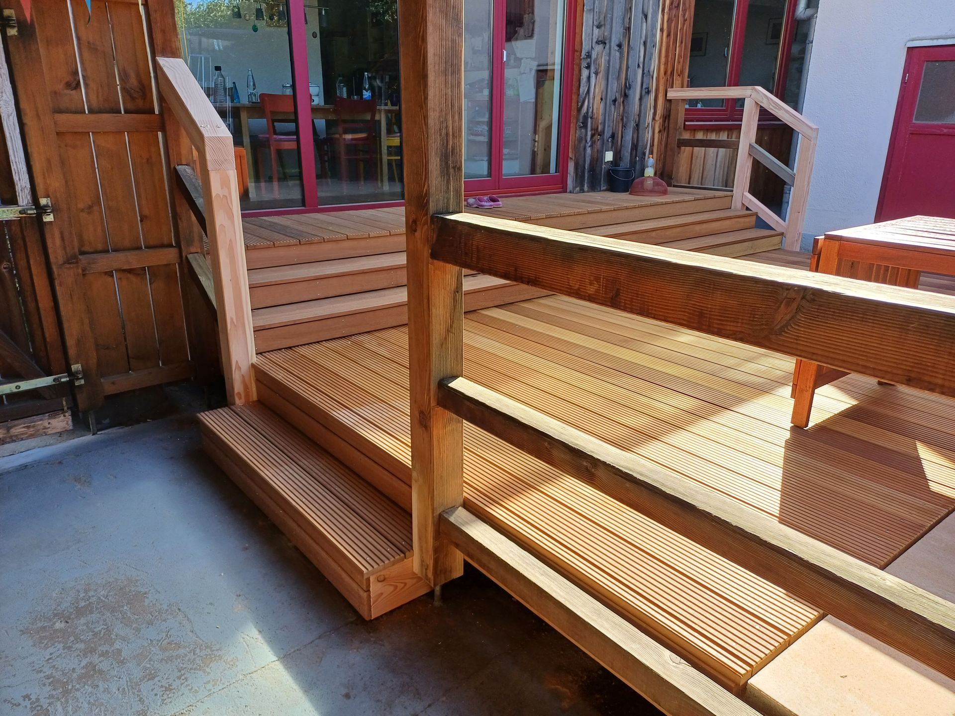 Eine Holzterrasse mit Treppen und einem Holzgeländer