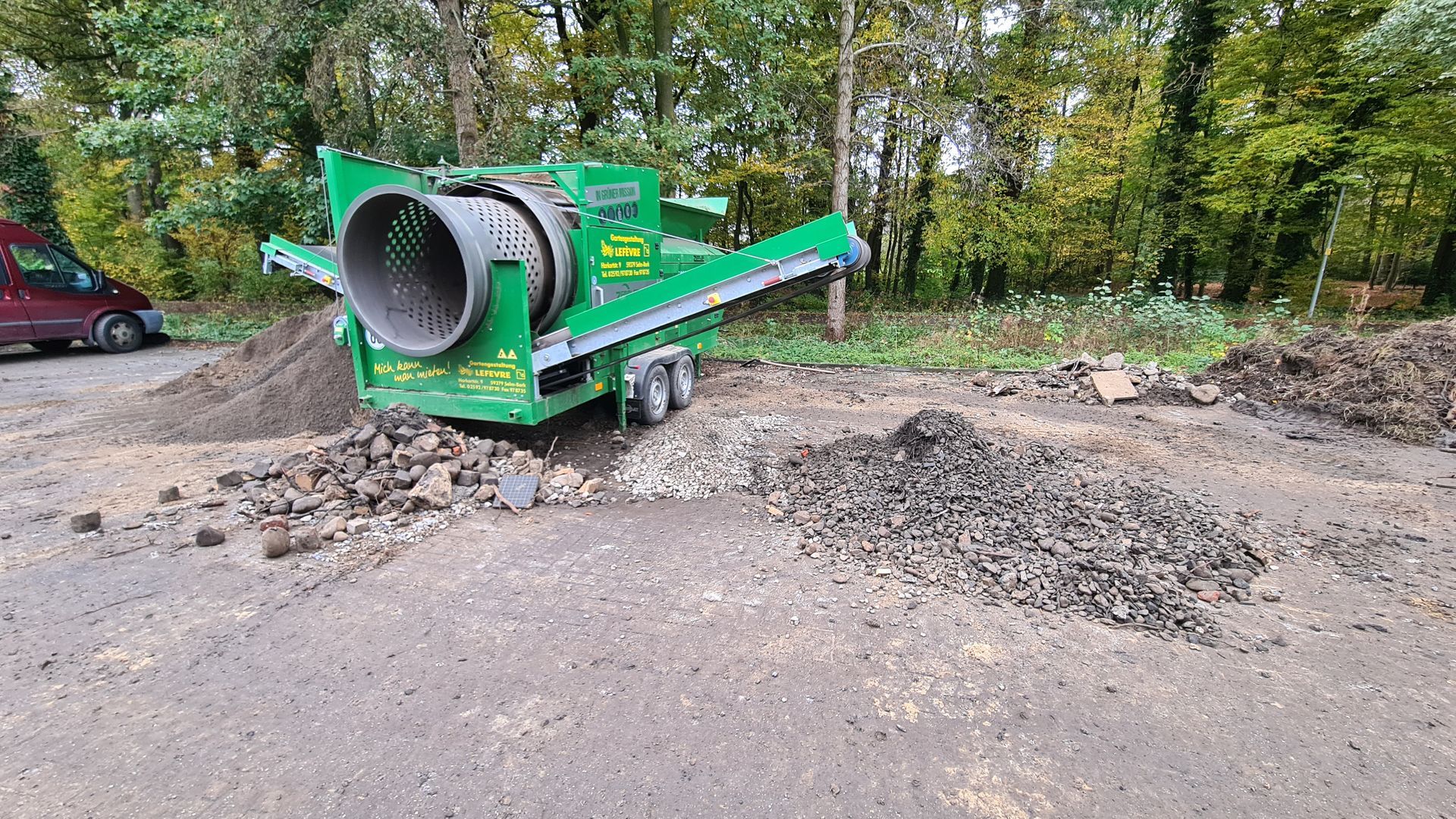 Eine grüne Maschine steht mitten auf einem Feld