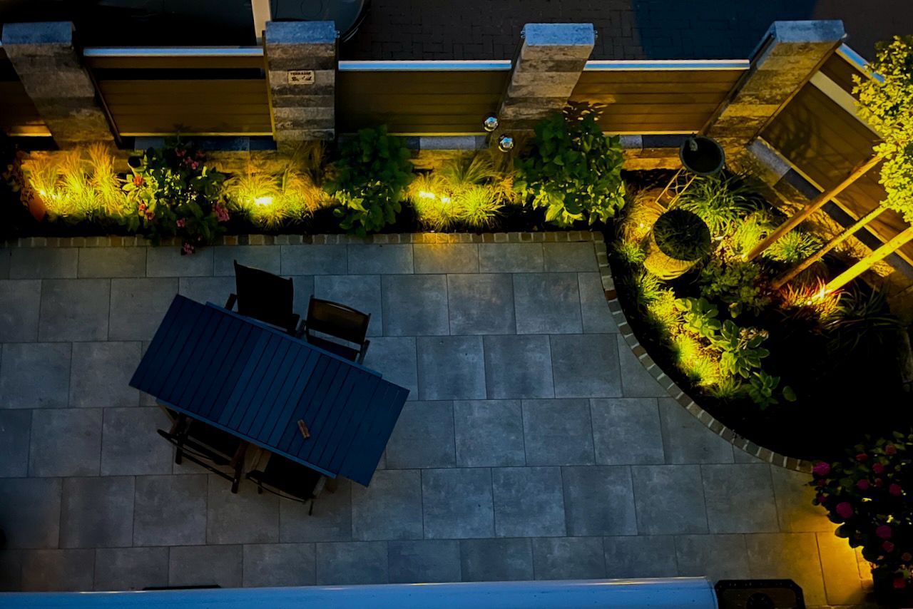 Eine Luftaufnahme einer Terrasse mit einem Tisch und Stühlen bei Nacht
