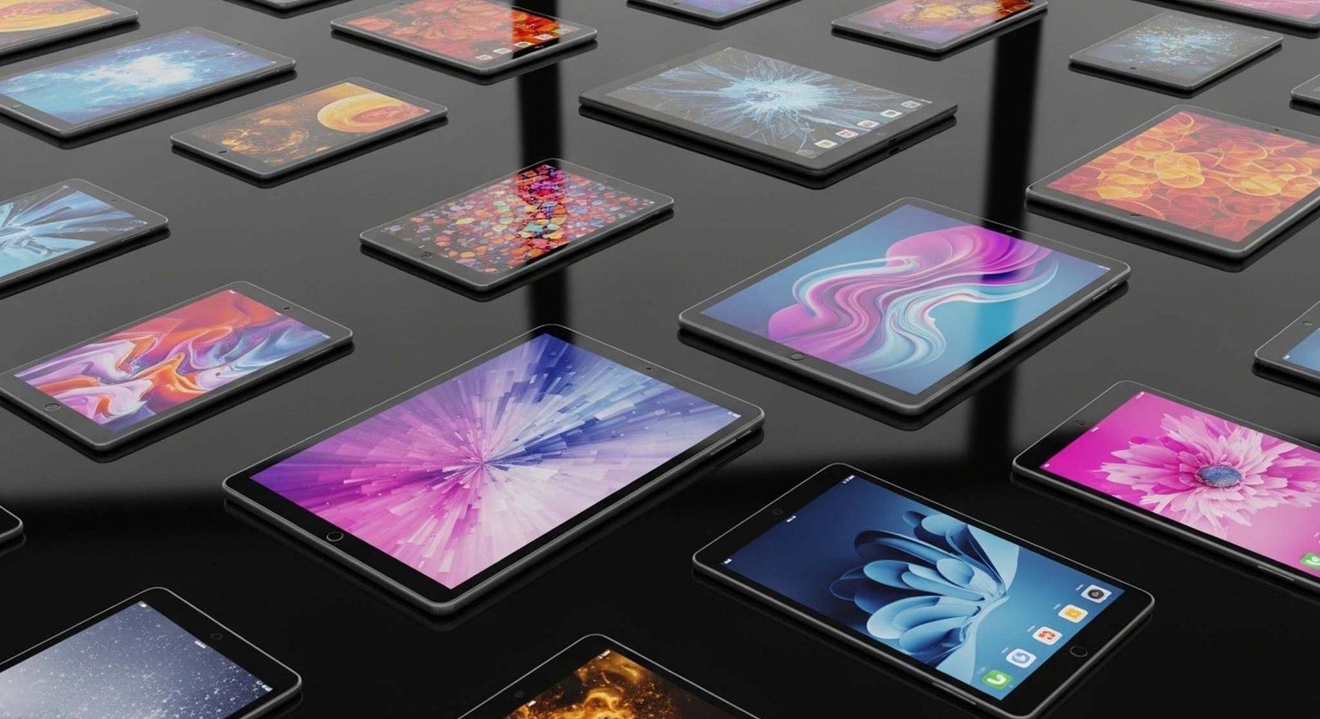 Varios teléfonos inteligentes sobre una superficie oscura, cada uno mostrando coloridos fondos de pantalla abstractos.