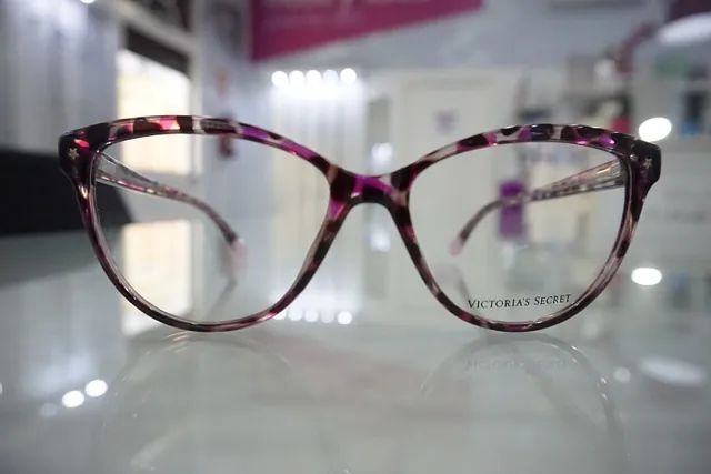 Un par de gafas colocadas encima de una mesa de cristal.