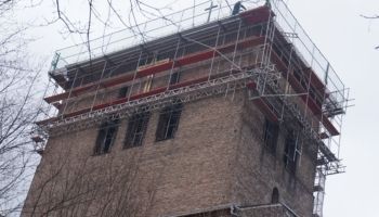 Ein Backsteingebäude mit einem Gerüst darauf.