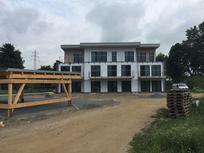 Ein im Bau befindliches Gebäude mit einem davor geparkten Auto.