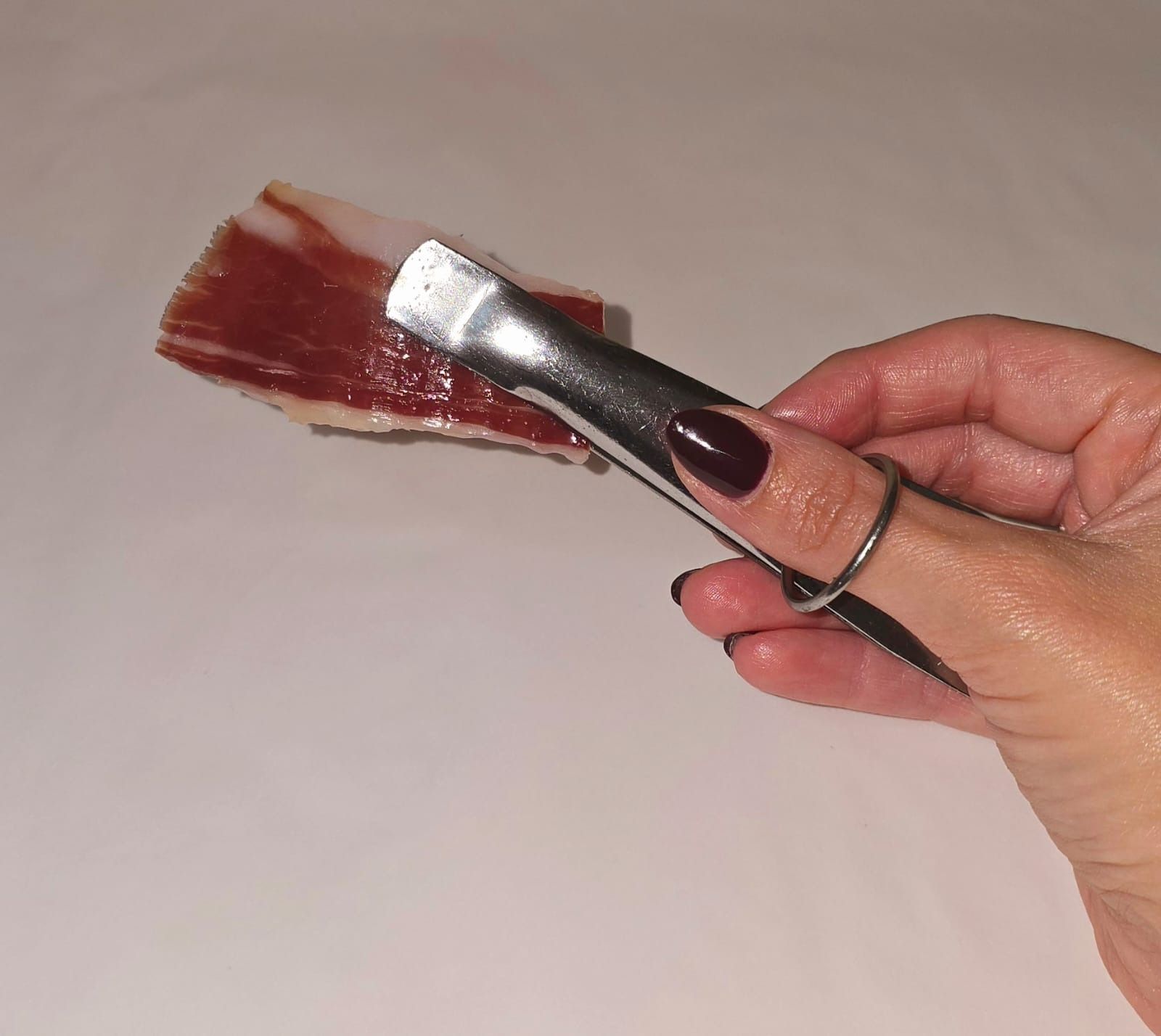 Una persona que sostiene un trozo de carne en la mano