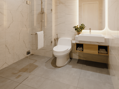 Salle de bain moderne avec toilettes blanches, lavabo, murs en marbre, douche en verre et carrelage au sol gris.