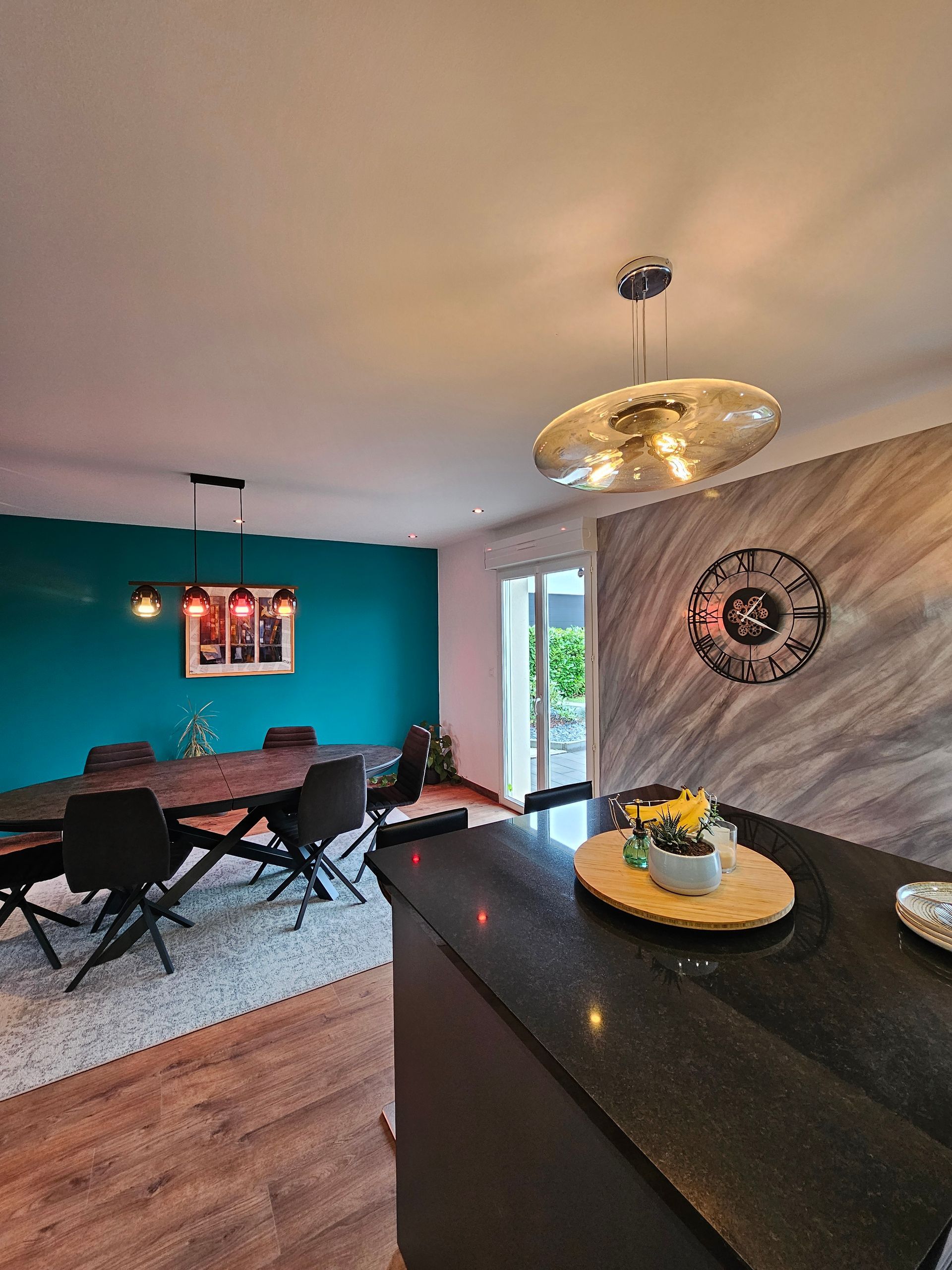 L'angle d'un plan de travail, une table ovale et un mur bleu canard