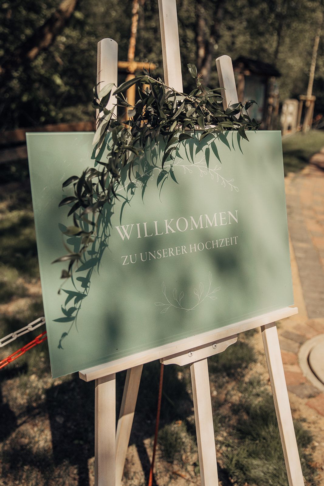 White easel with a teal sign that says 