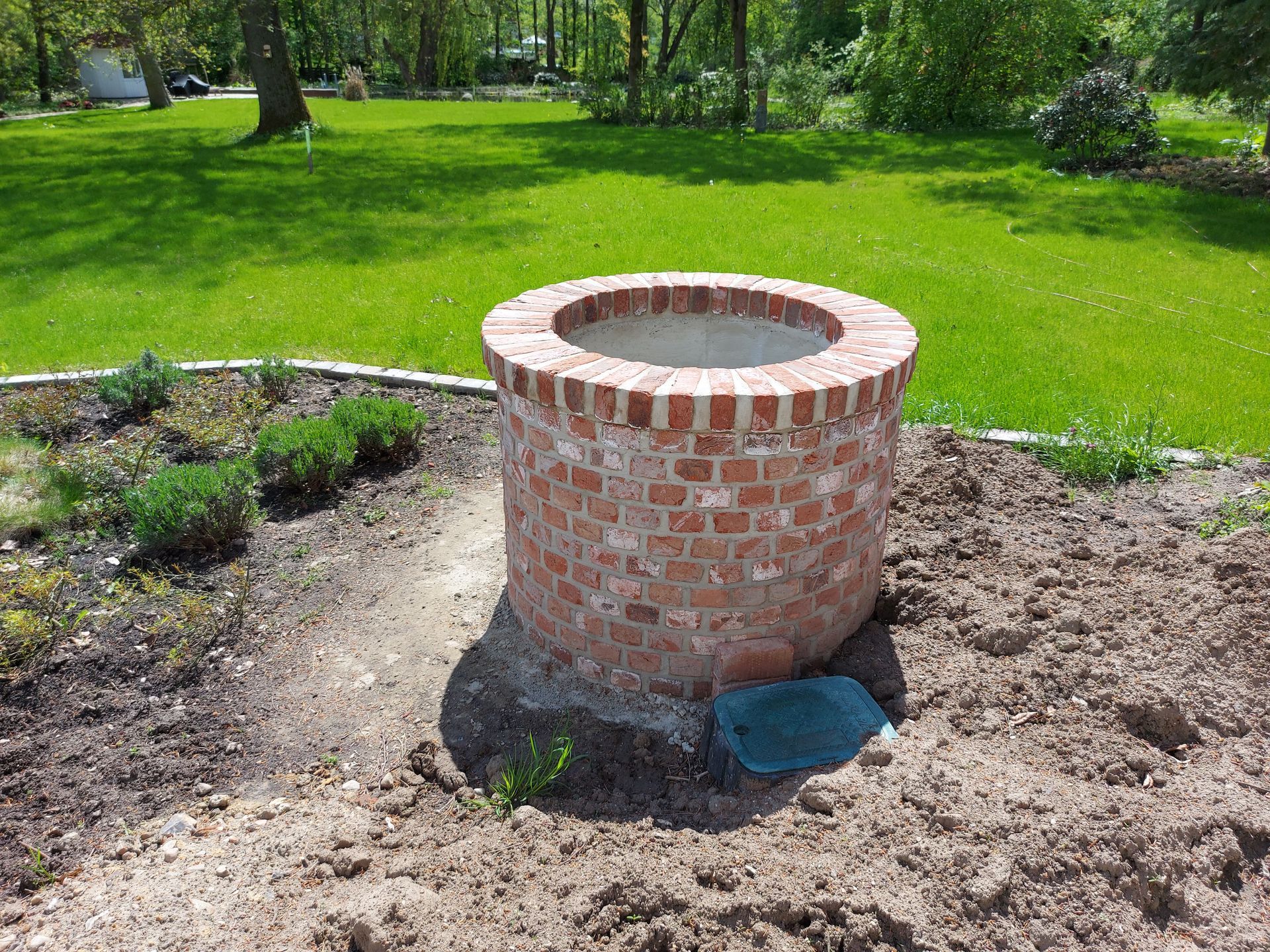 Ein neu errichteter Ziegelsteinbrunnen.