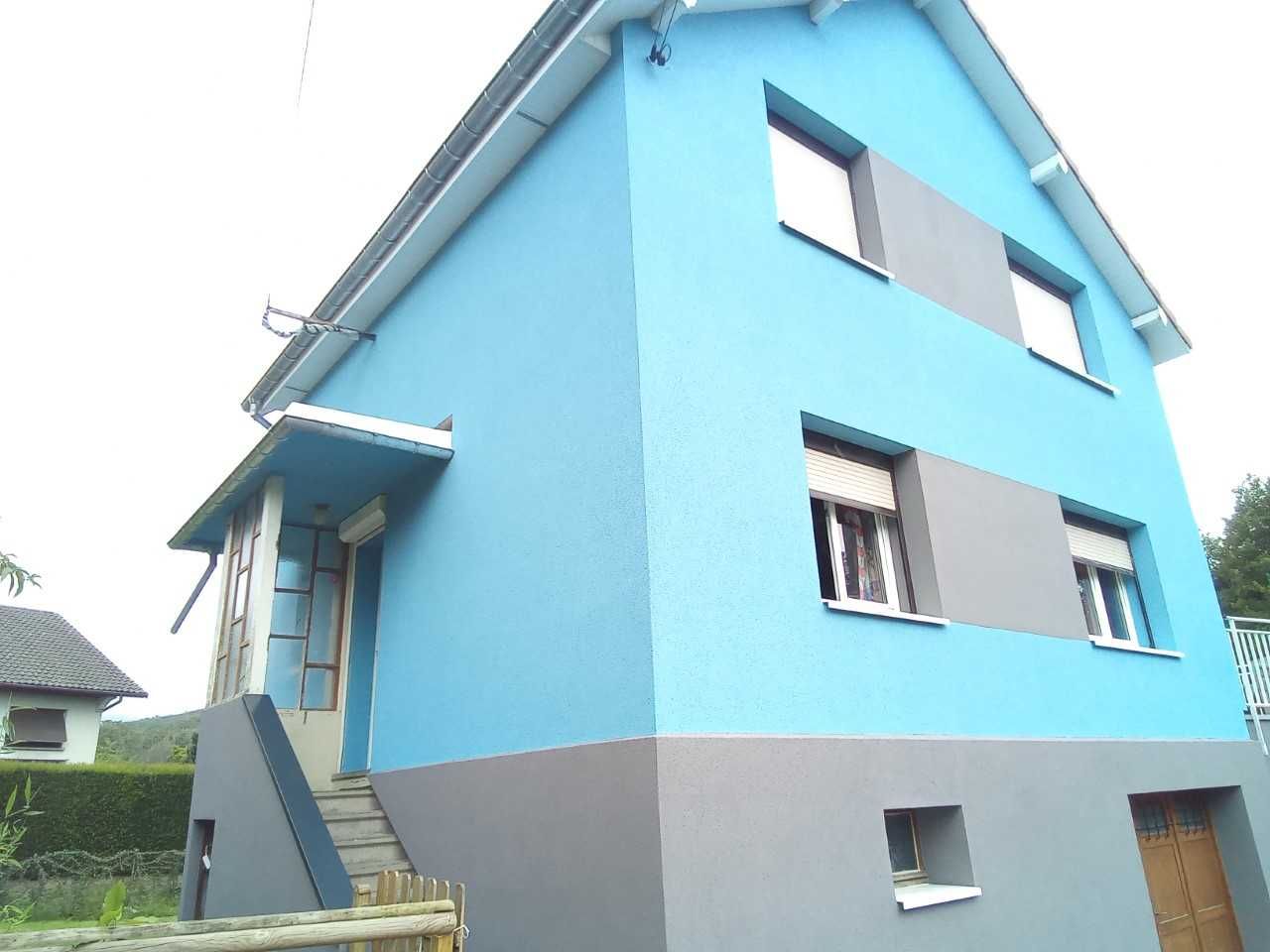 Façade bleue d'une maison à trois étages