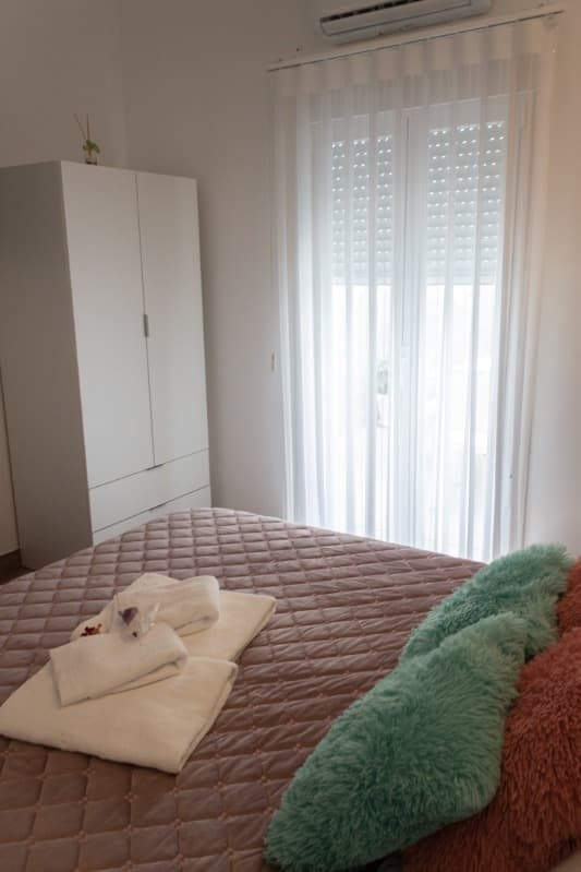 Un dormitorio con una cama y una ventana con persianas.