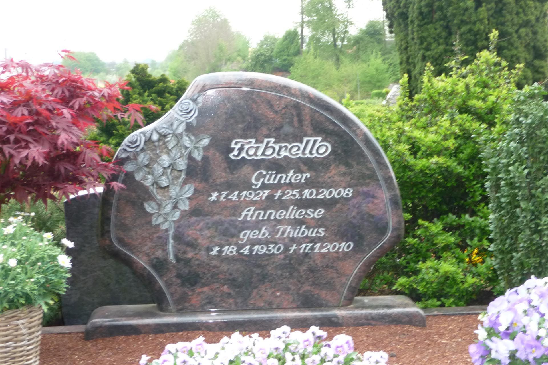 Ein runder Grabstein mit Schriftzug und Blume von der Grabmale Lehmann GmbH & Vosberg