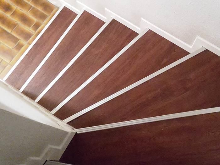 Eine Treppe mit Holzstufen und weißen Zierleisten