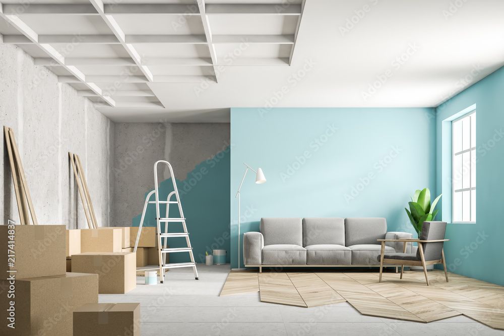 Bright living room renovation with boxes, ladder, sofa, teal wall, and large window