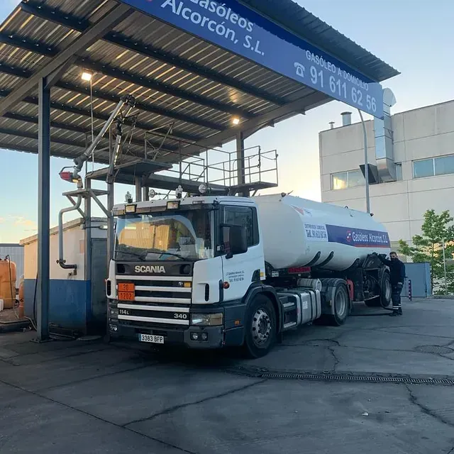 Un camión Scania está estacionado en una gasolinera.
