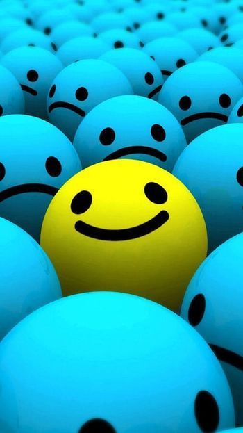 Cara sonriente amarilla rodeada de esferas azules con caras tristes.