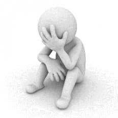 Figura de una persona sentada con la cabeza entre las manos y con aspecto abatido.