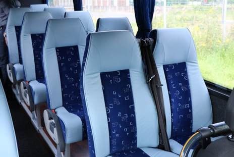 Eine Reihe blau-weißer Sitze in einem Bus.