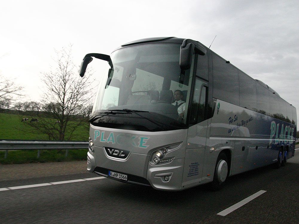 Ein silberner Bus mit dem Wort „Plane“ auf der Vorderseite