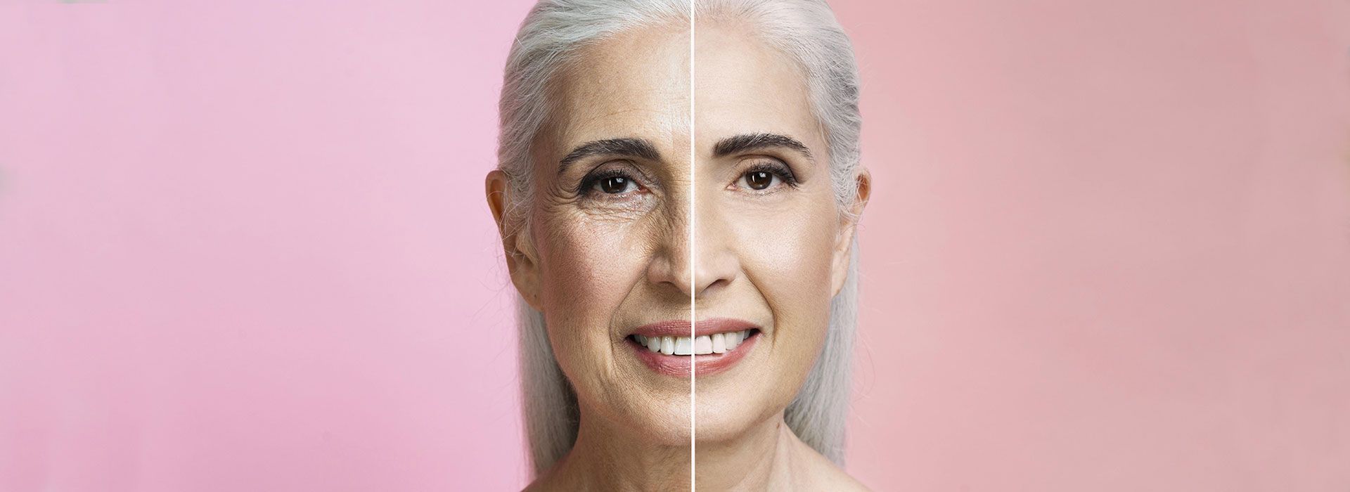 Una mujer de cabello gris sonríe delante de un fondo rosa.