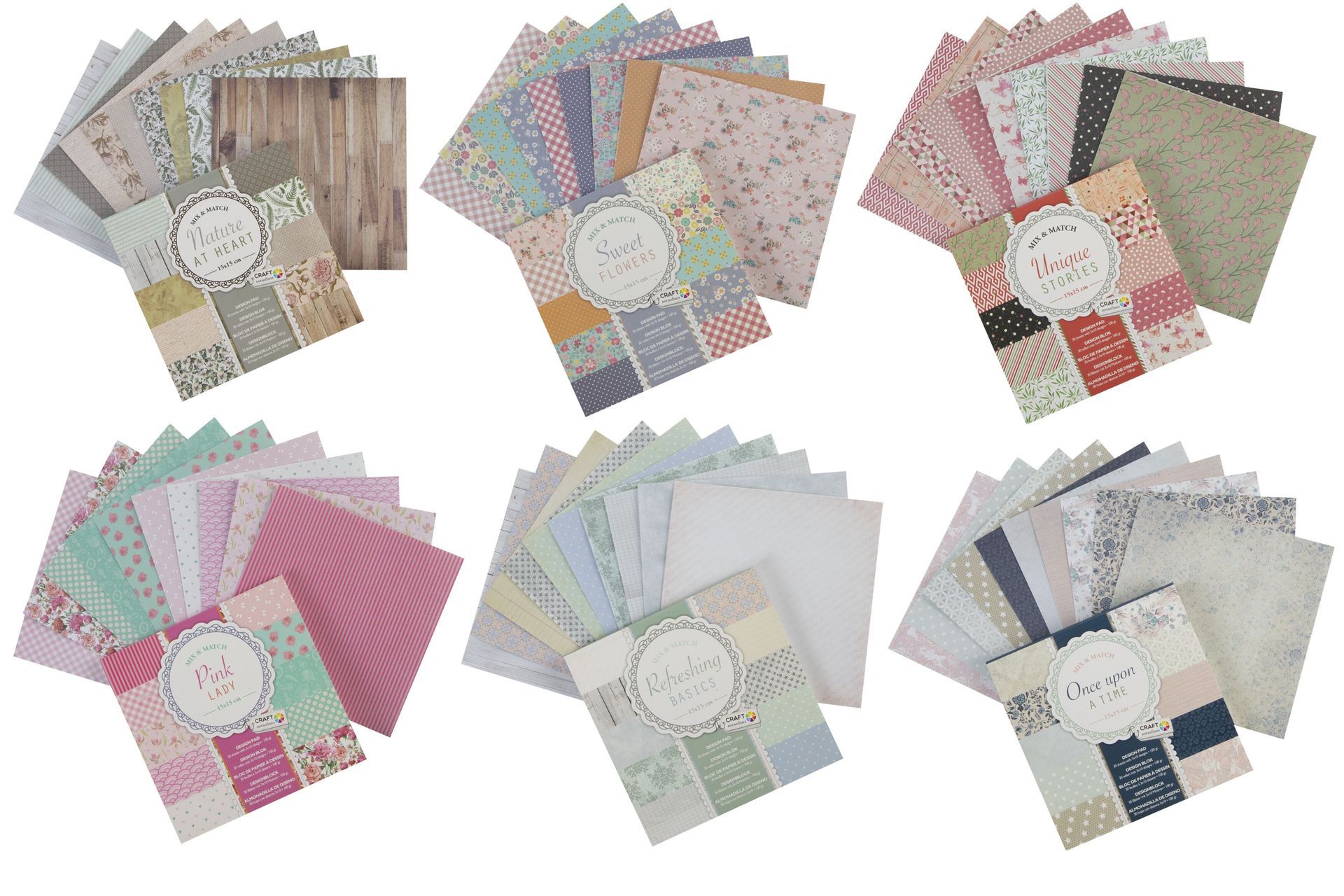 Kuusi pinoa kuviollista scrapbooking-paperia kahteen riviin valkoisella taustalla
