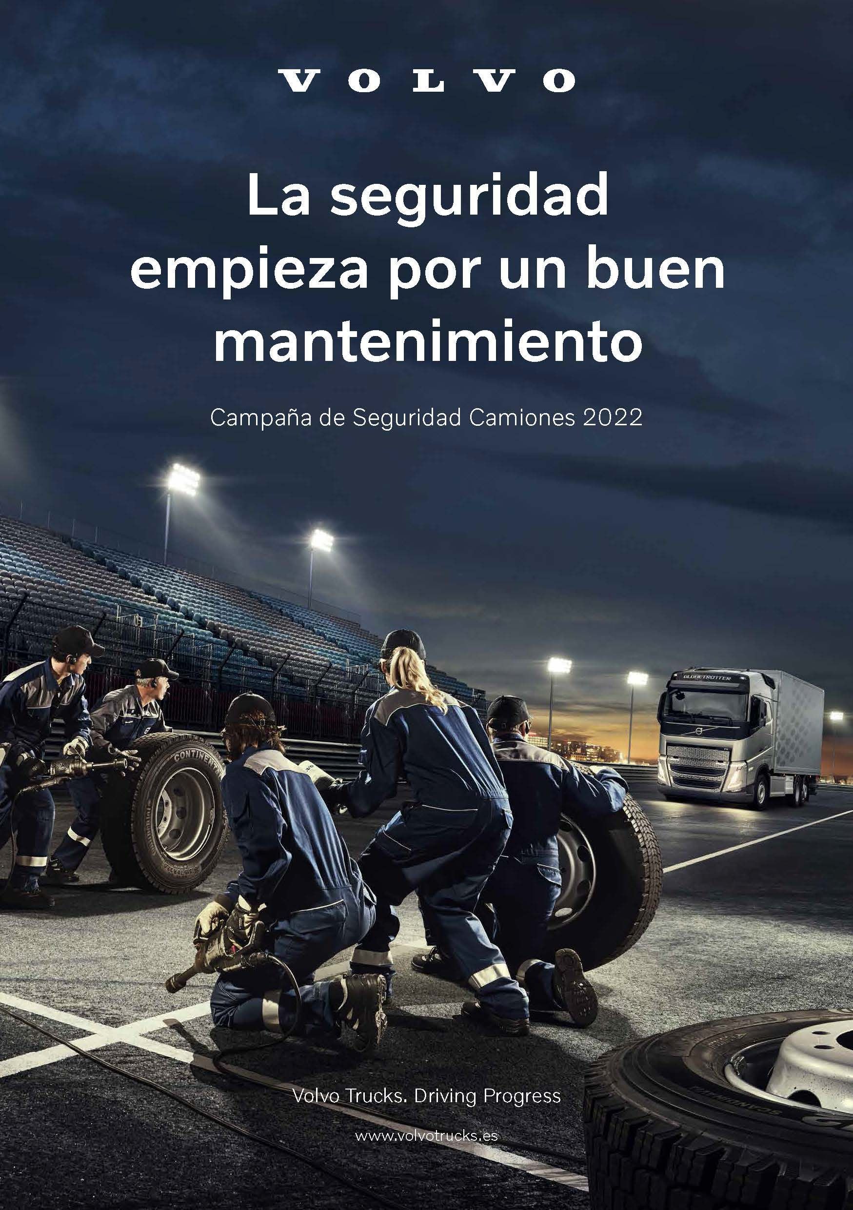 Anuncio de Volvo: Mecánicos trabajando en neumáticos de camiones en un estadio, texto "La seguridad comienza con un buen mantenimiento".